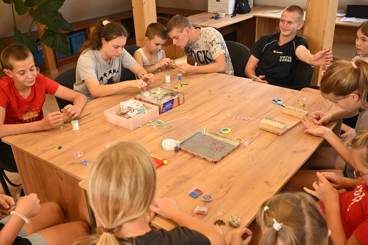 Children weave beaded bracelets at one of the Ark of Peace workshops Children weave beaded bracelets at one of the Ark of Peace workshops